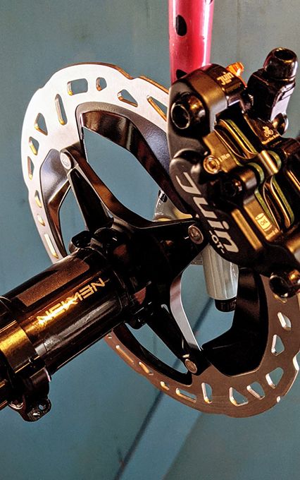 juin-tech-gt-disc-brake-rotor-mounted-to-Newmen-road-evolution-bike-hub-front.jpeg