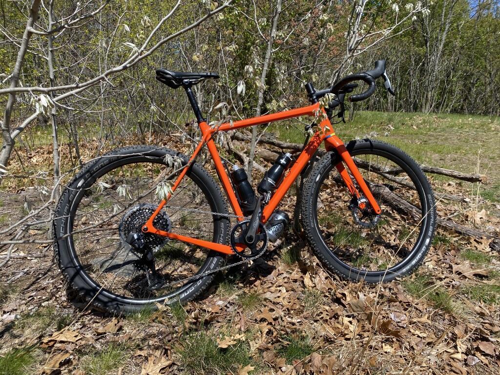 Light-Bicycle-paintless-XC725-flyweight-cross-country-carbon-wheelset-with-schwalbe-g-one-tires-on-orange-gravel-bike-frame
