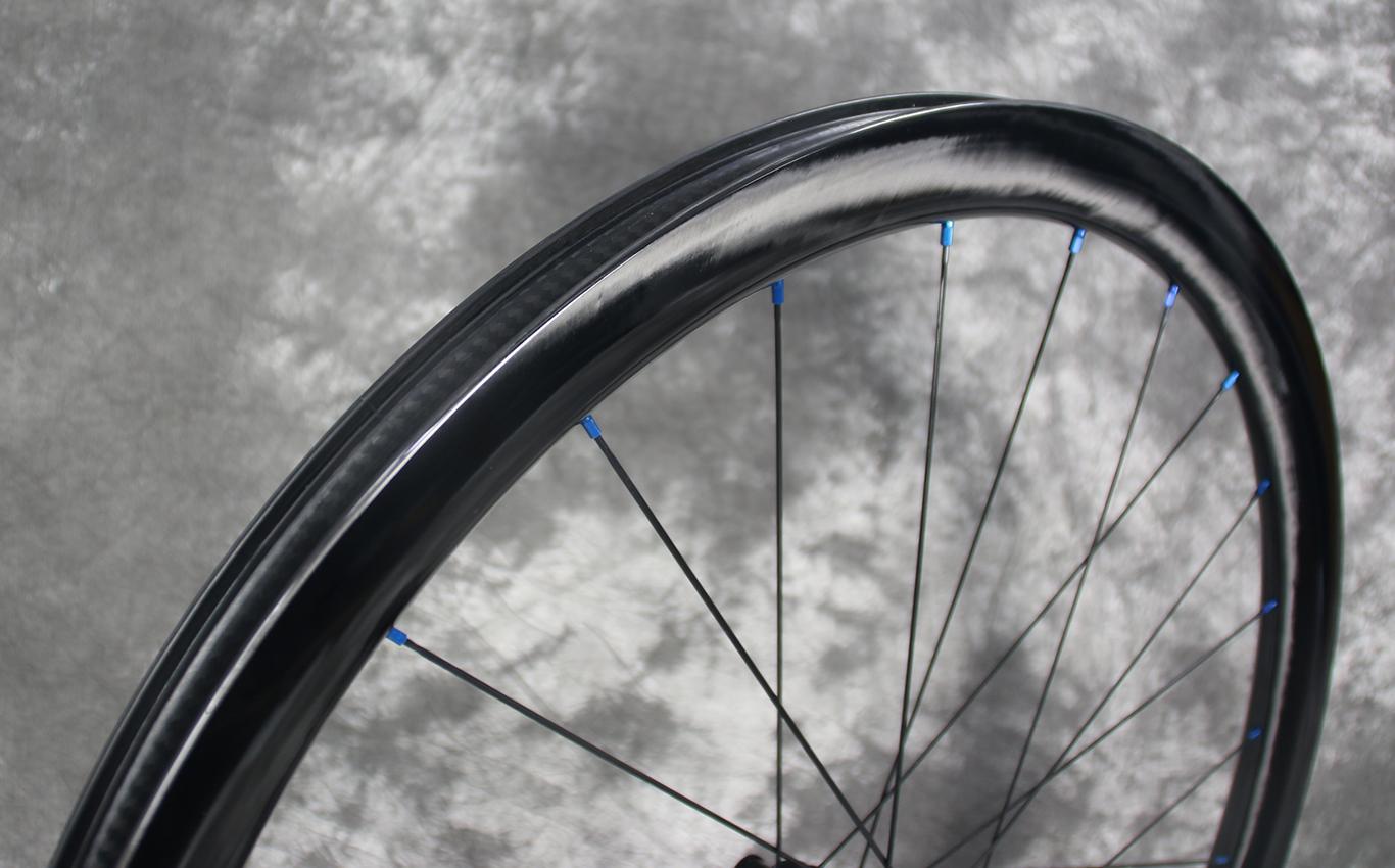 wr38-carbon-rim-paintless-finish-with-blue-spoke-nipples